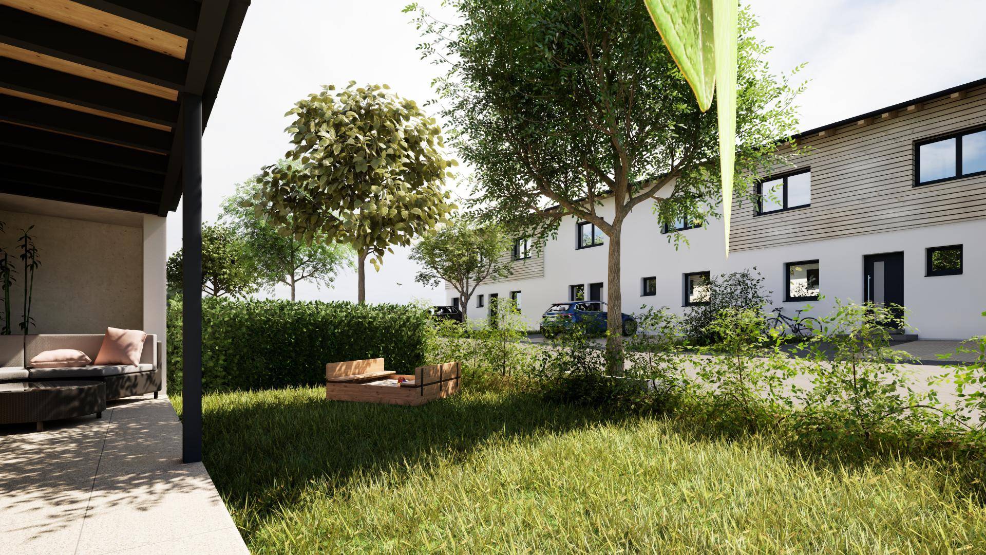 Blick vom privaten Gartenbereich mit überdachter Terrasse und Rasenfläche auf die modernen Reihenhäuser.