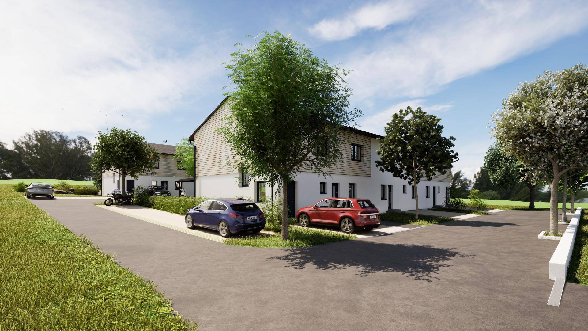 Seitenansicht der modernen Reihenhäuser mit Parkplätzen und umgebender grüner Landschaft.