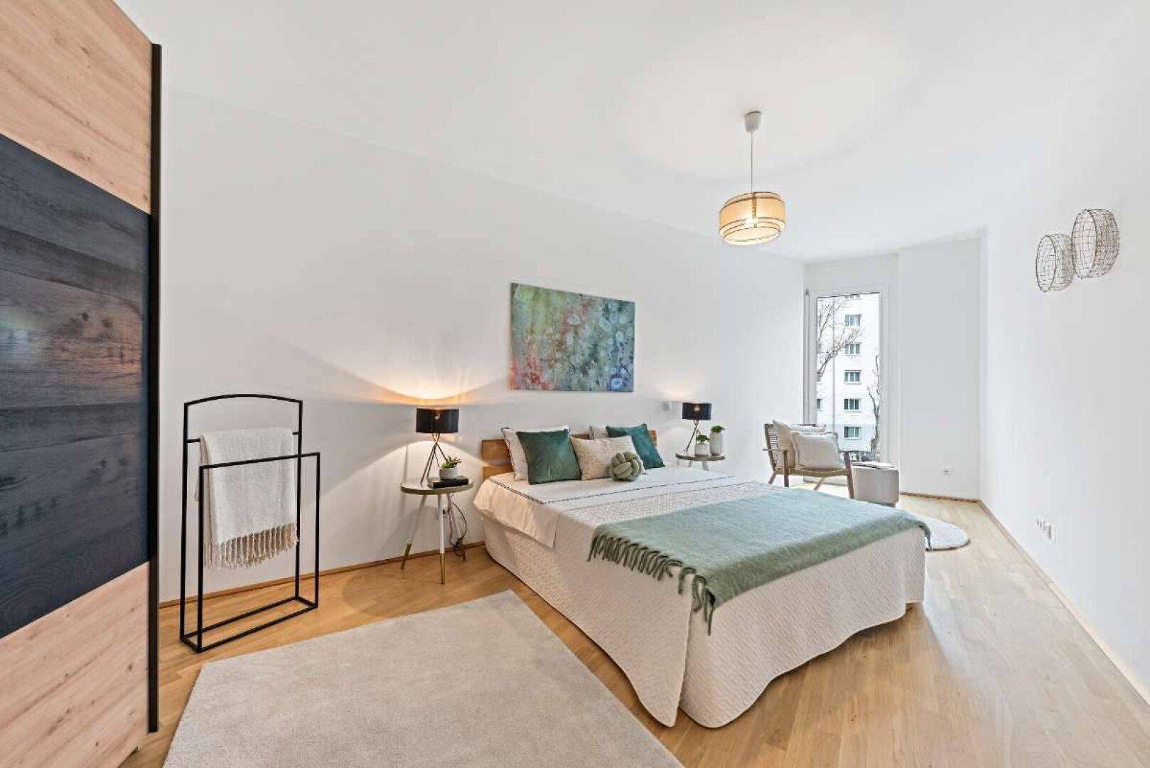 Geräumiges Schlafzimmer mit Holzboden, Doppelbett und stilvoller Beleuchtung sowie Tageslicht.