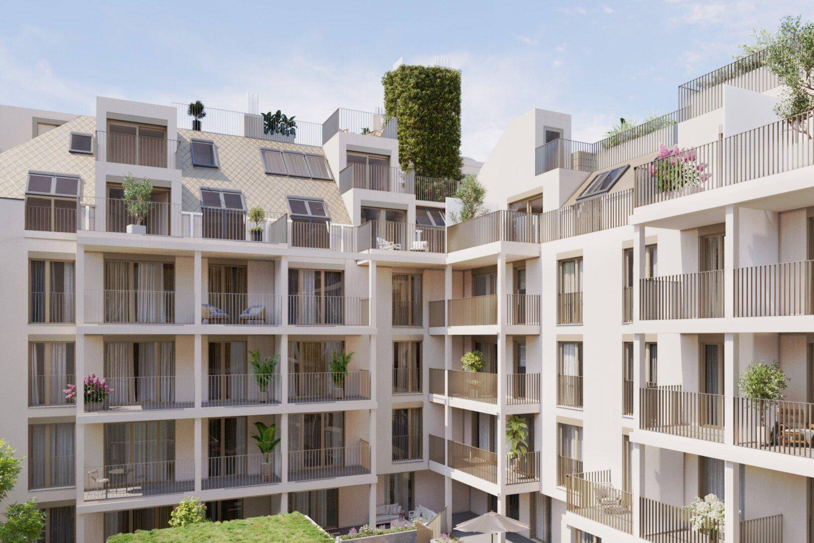 Moderne Wohnanlage mit zahlreichen Balkonen und Dachterrassen, umgeben von Grünflächen.
