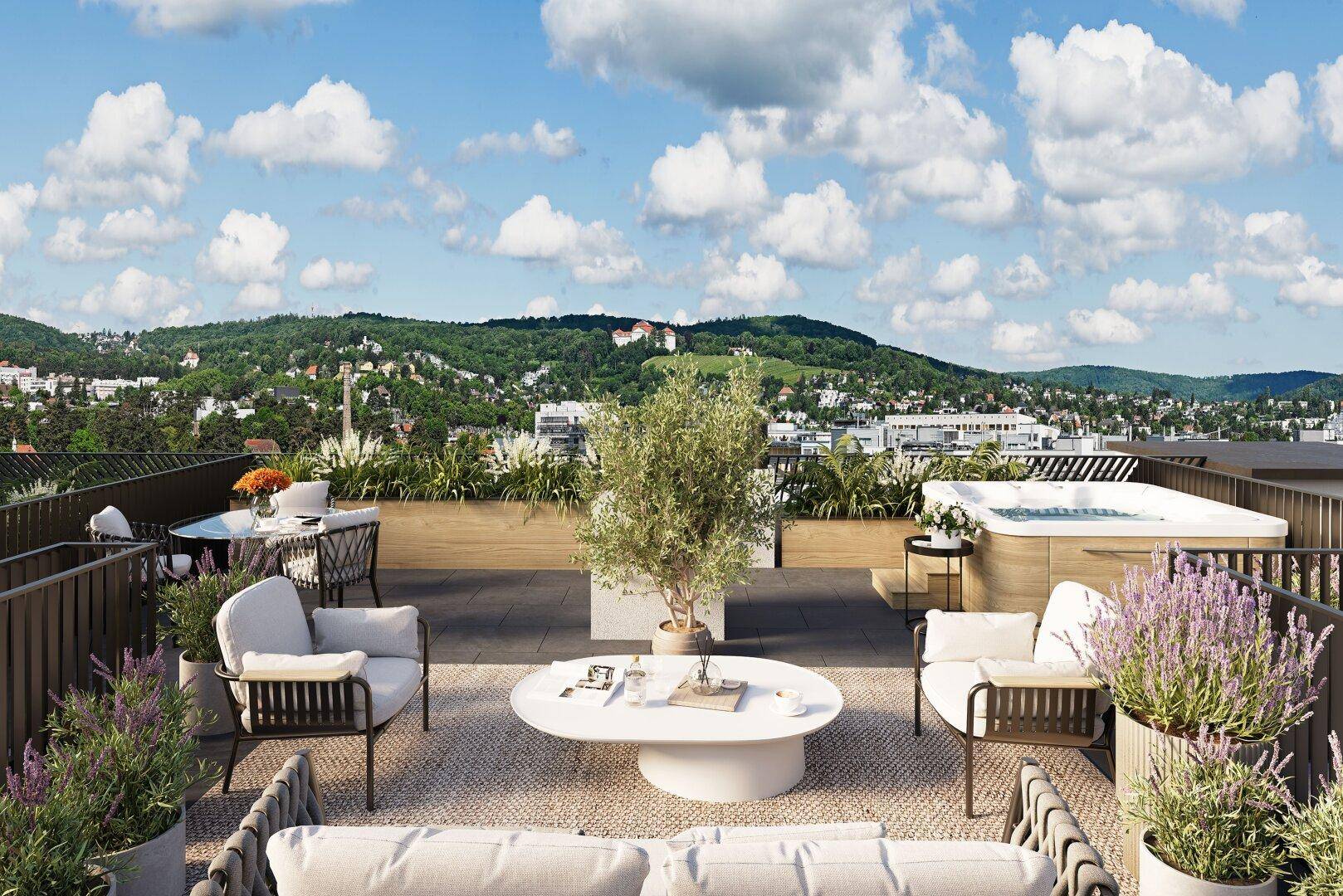 Exklusive Dachterrasse mit Whirlpool, Essbereich und Panoramablick über die Stadt und Landschaft.
