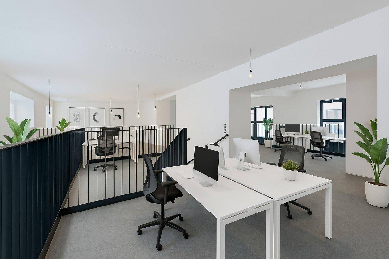Modernes, offenes Büro mit mehreren Arbeitsplätzen auf zwei Ebenen, hohen Decken und viel Tageslicht.