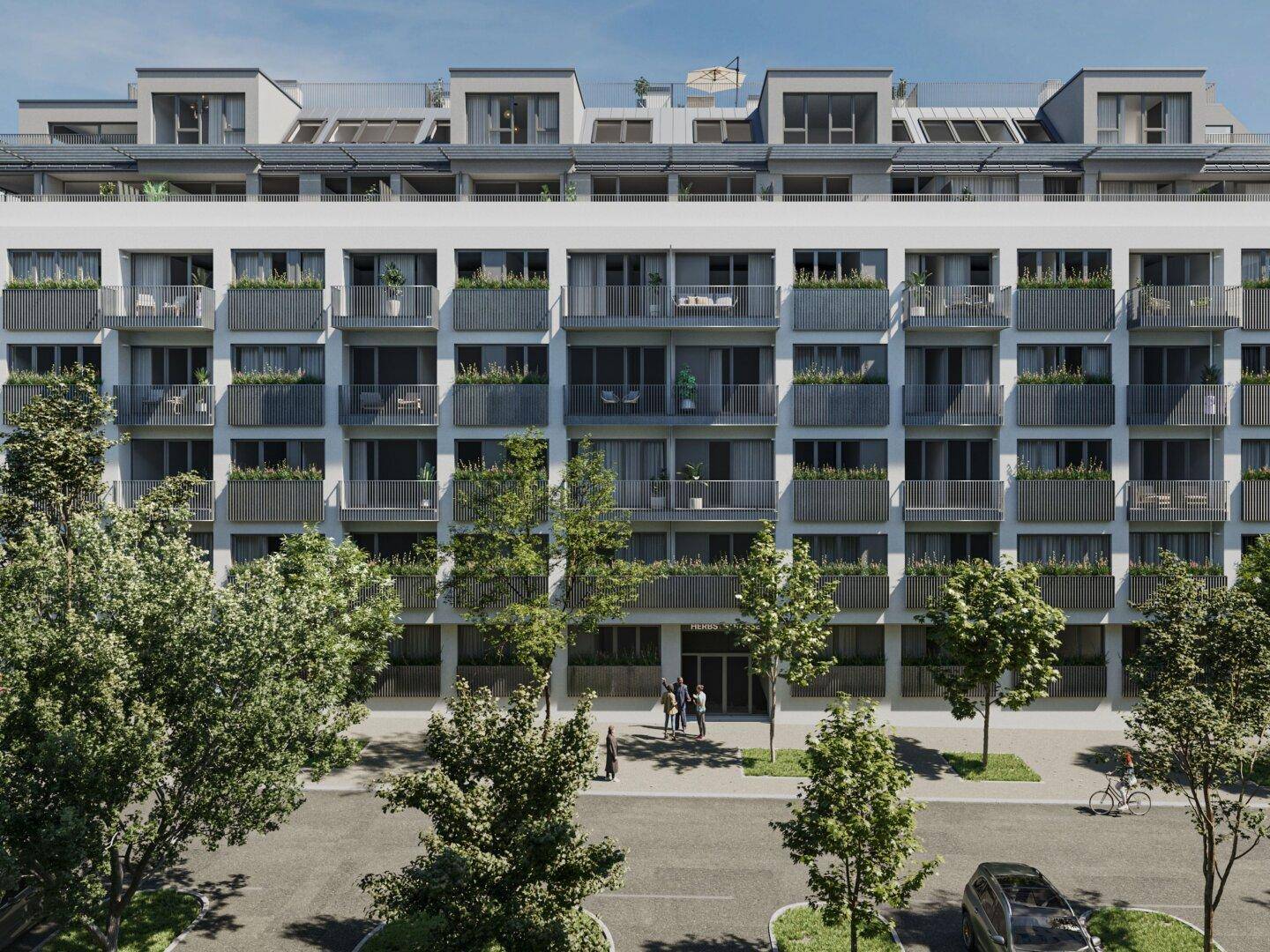 Moderne Wohnanlage mit zahlreichen Balkonen und grüner Bepflanzung an der Fassade in urbaner Umgebung.