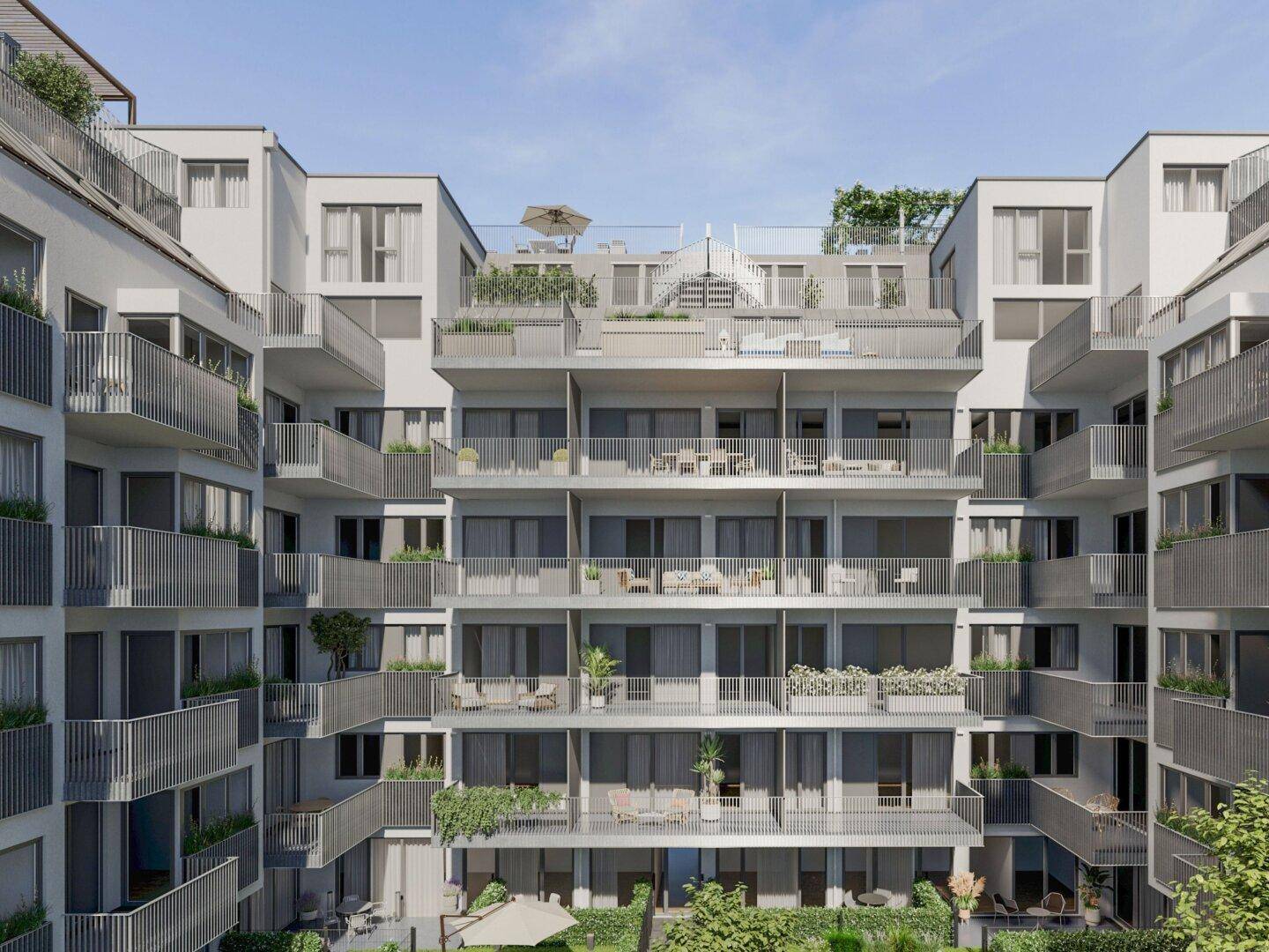 Moderne Wohnanlage mit zahlreichen Balkonen und Dachterrassen in urbaner Umgebung.