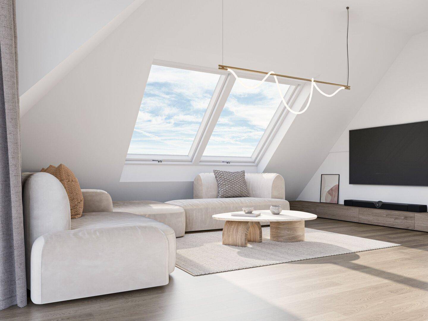 Gemütliches Wohnzimmer im Dachgeschoss mit schrägen Wänden und großen Dachfenstern.