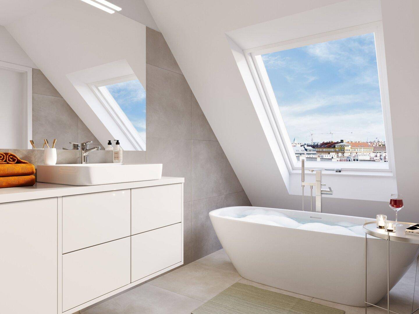 Modernes Badezimmer im Dachgeschoss mit freistehender Badewanne und großen Dachfenstern.