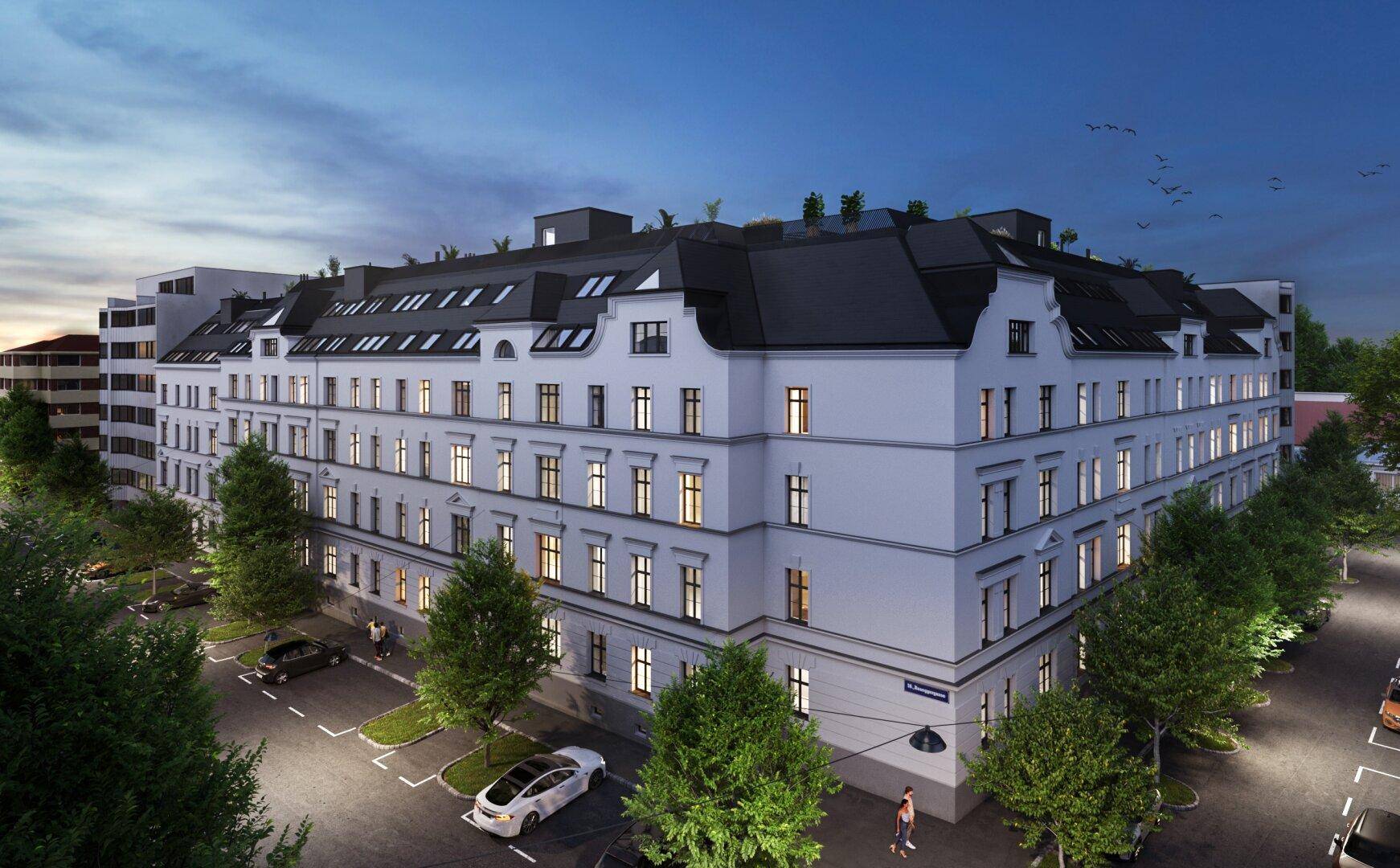 Klassisches Wohngebäude mit eleganter Fassade und beleuchteten Fenstern in der Abenddämmerung.