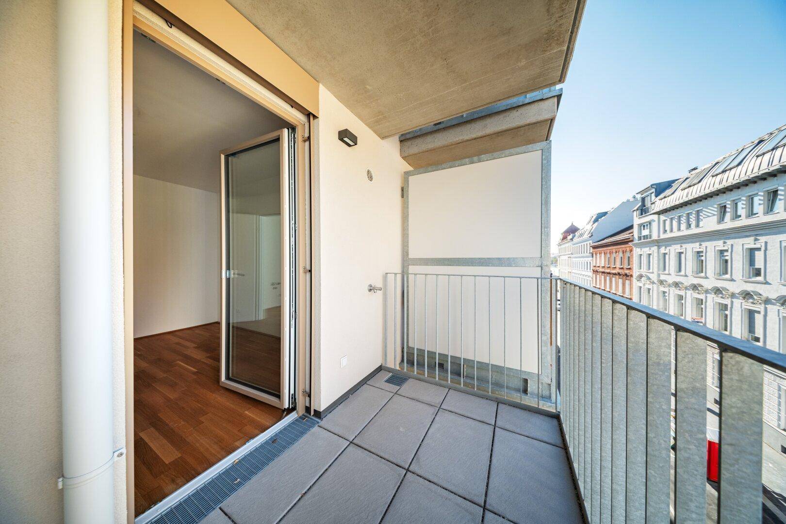 Geräumiger Balkon mit Fliesenboden und Zugang zum Innenraum, ideal für entspannte Stunden im Freien.
