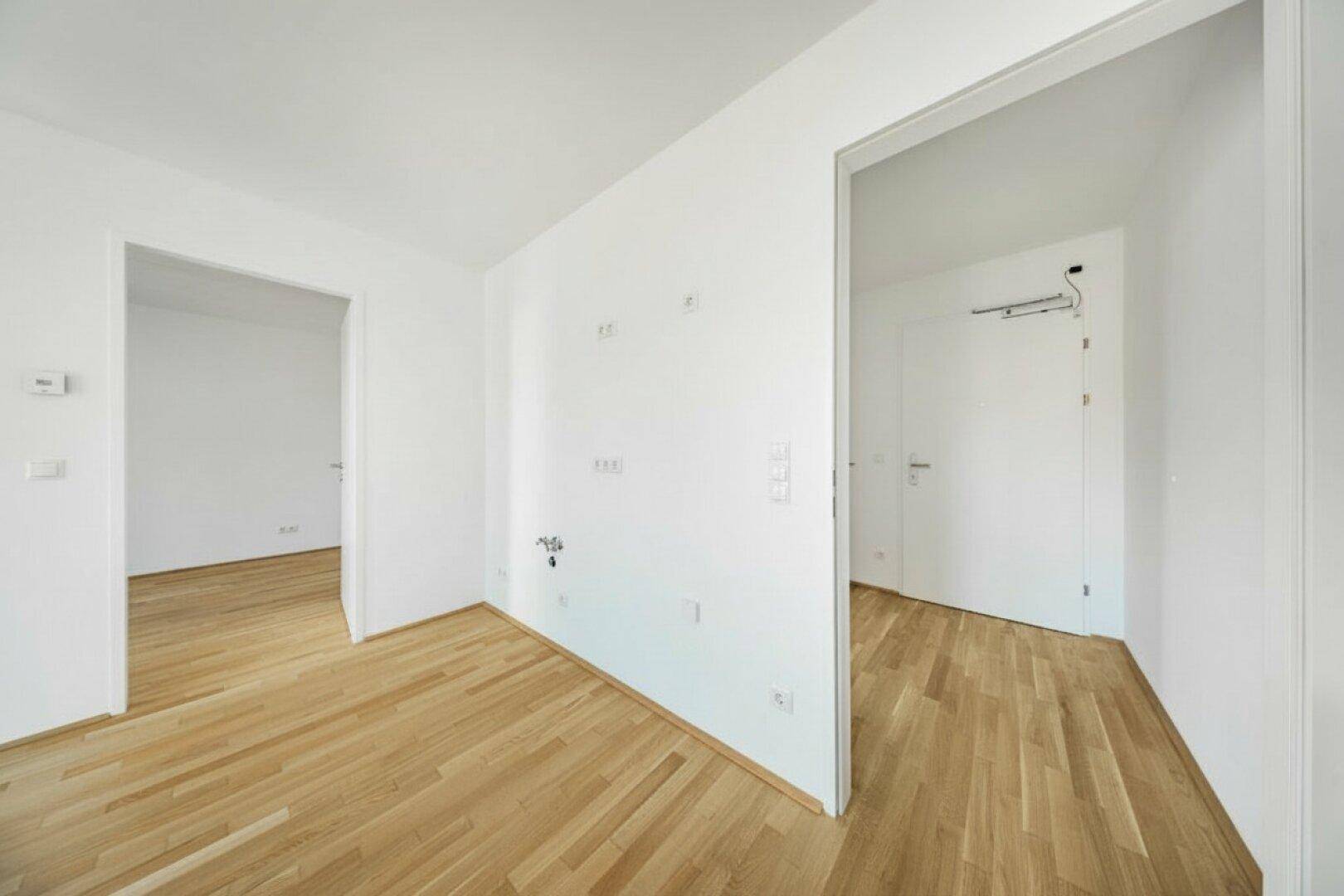 Geräumiger Flur mit Parkettboden und Zugang zu verschiedenen Räumen der Wohnung.