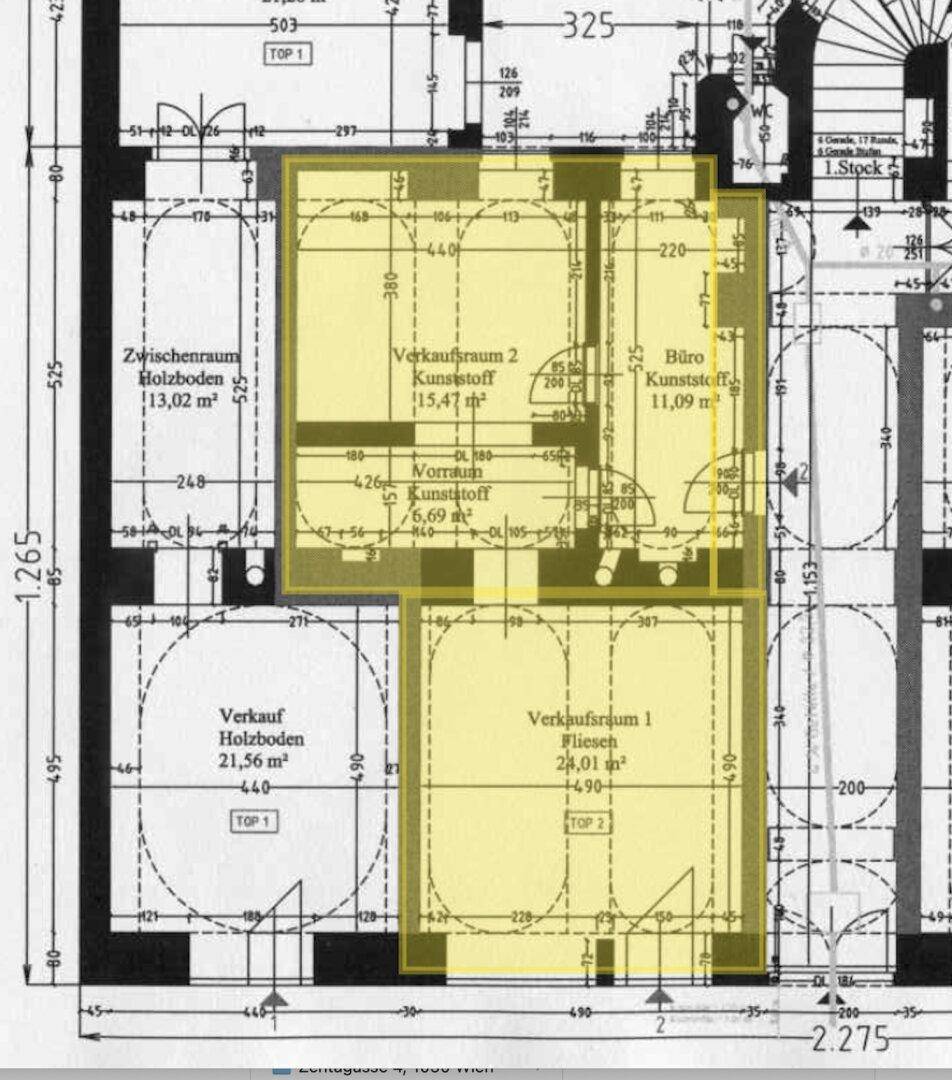 Detaillierter Grundriss mit hervorgehobenen Verkaufs- und Büroräumen sowie einer Wendeltreppe.