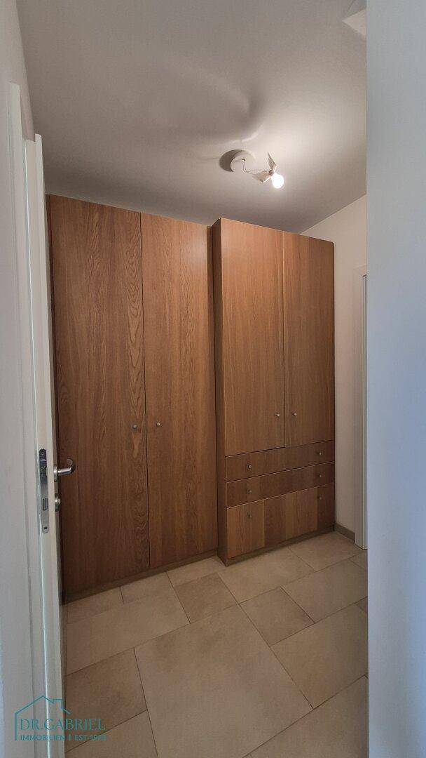 Geräumige Einbauschränke aus Holz bieten viel Stauraum in diesem Bereich.