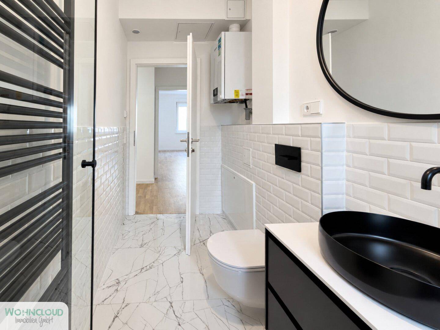Stilvolles Badezimmer mit WC, modernem Waschtisch und Heizkörper, mit Zugang zu weiterem Raum.