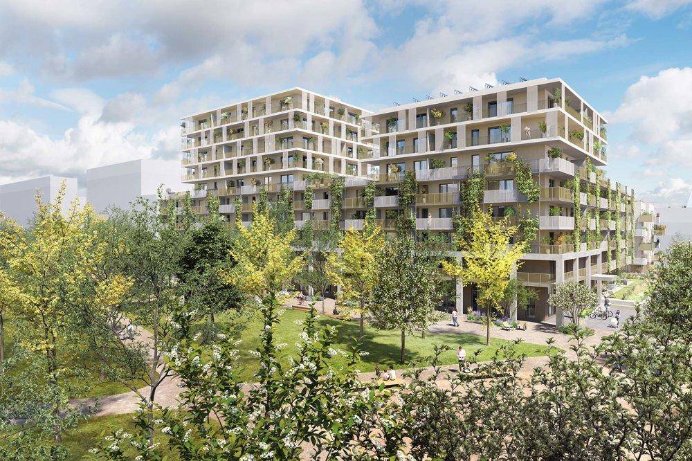 Moderne Wohngebäude mit begrünten Fassaden und einem weitläufigen Park im Vordergrund.