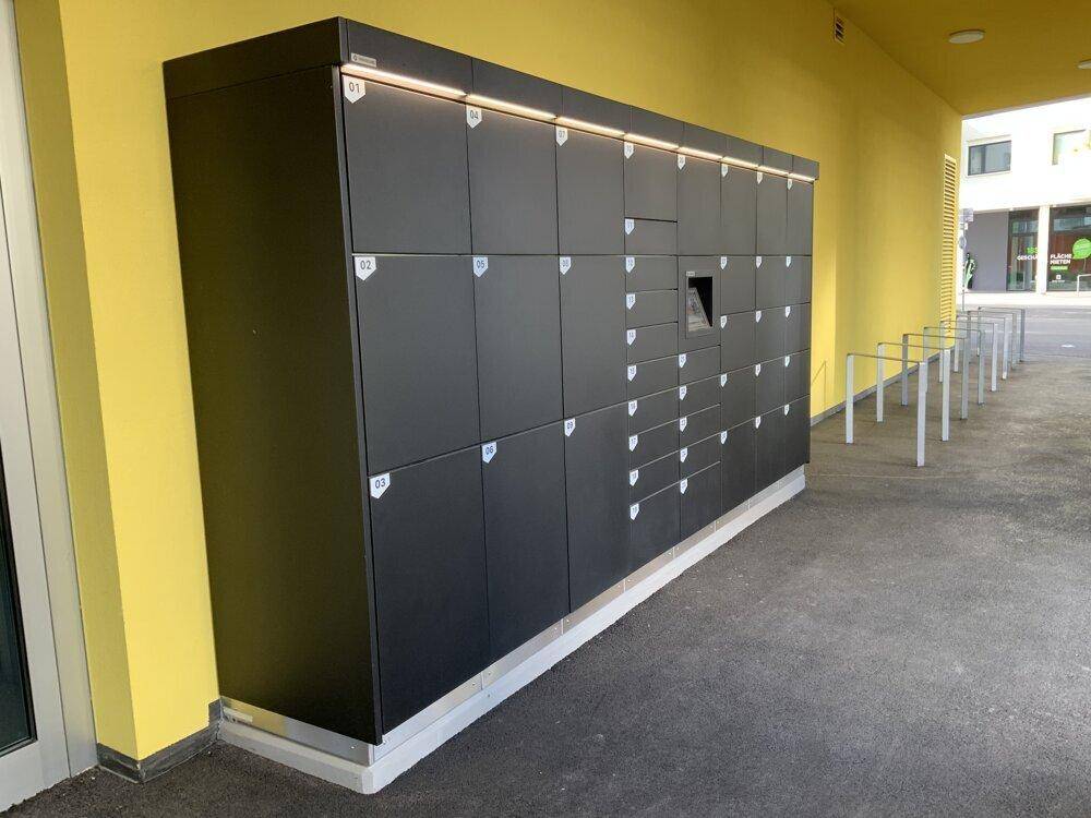 Moderne Paketstation im Außenbereich der Wohnanlage für bequeme Lieferungen.