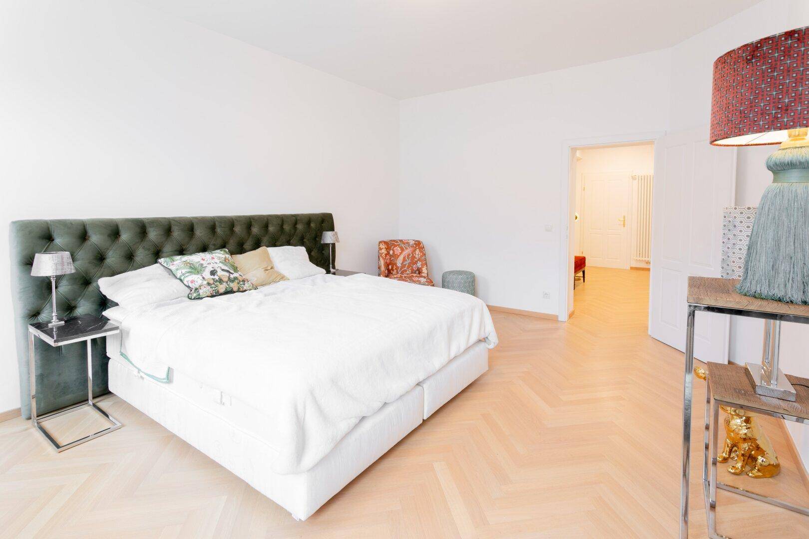 Geräumiges Schlafzimmer mit bequemen Doppelbett und Zugang zu einem weiteren Raum.