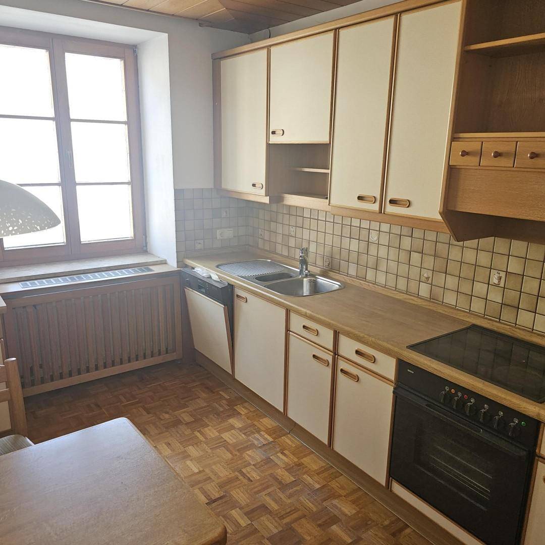 Küche im traditionellen Stil mit Holzelementen, Parkettboden und Fenster.