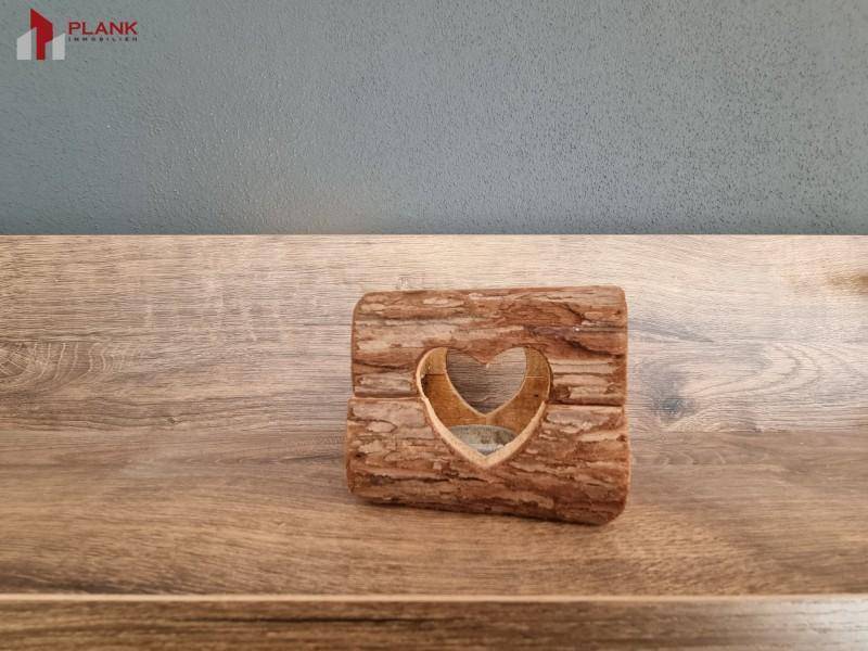 Rustikales Holzdekor mit Herzmotiv auf einer Holzoberfläche.