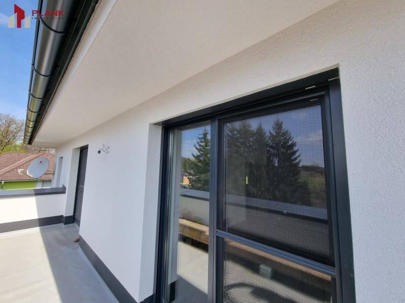 Geräumiger Balkon mit Schiebetür und Blick auf die umliegende Landschaft.