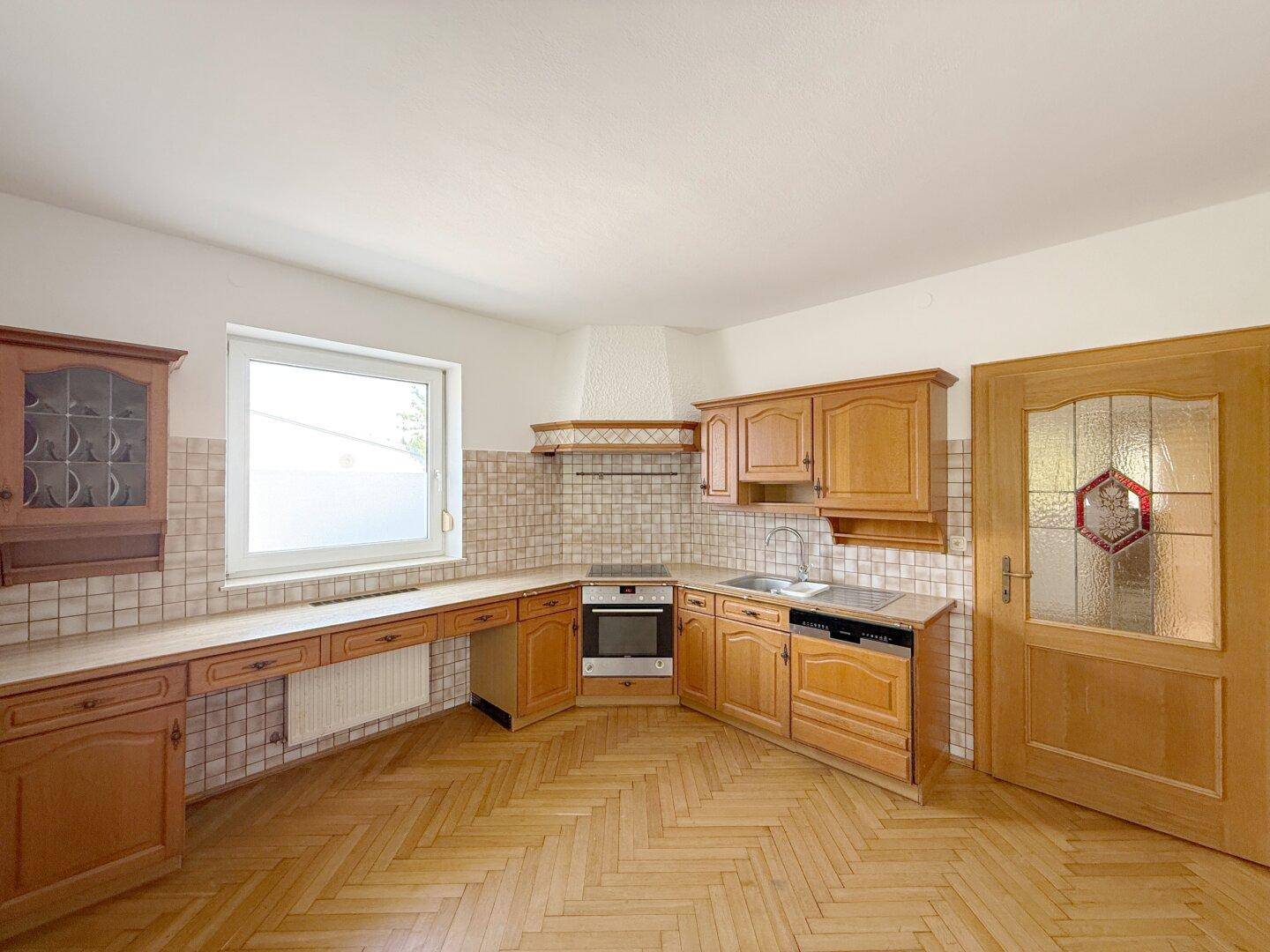 Gemütliche Holzküche mit traditionellen Fliesen und viel Stauraum in den Schränken.