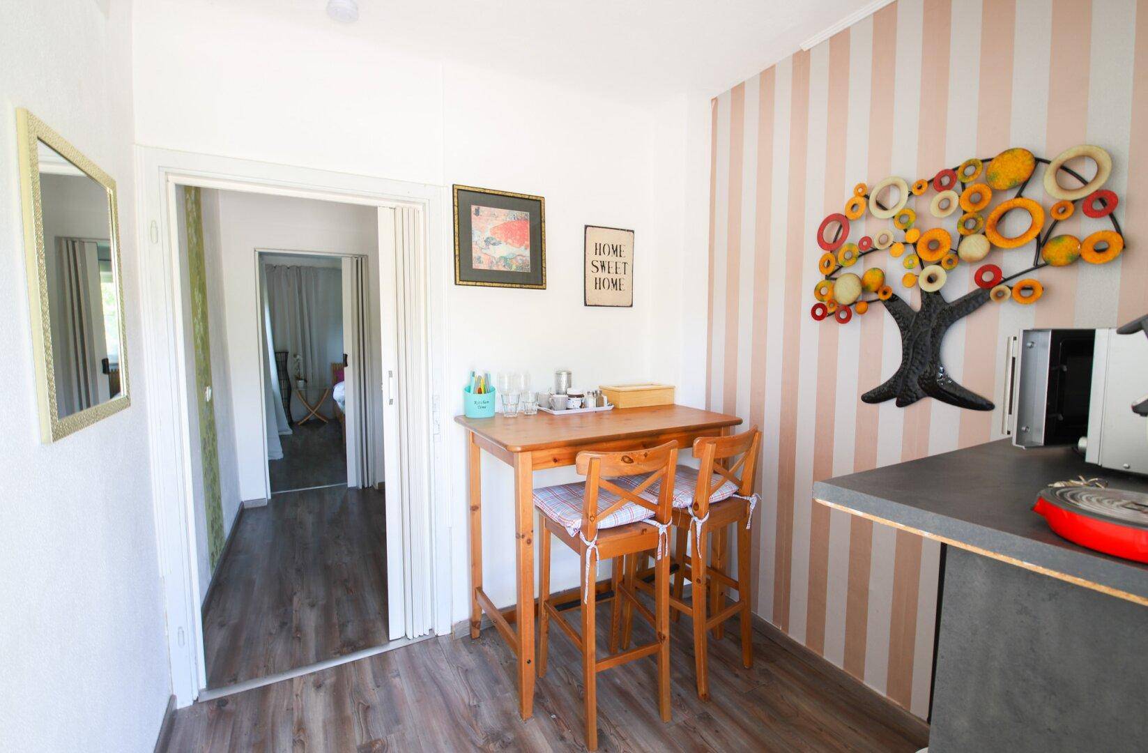 Kleiner Essbereich mit Holztisch und Stühlen, ideal für Frühstück oder schnelle Mahlzeiten.
