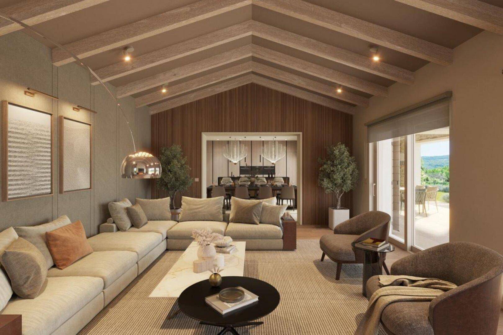 Geräumiges Wohnzimmer mit hohen Holzbalkendecken, bequemen Sofas und Zugang zu einer Außenterrasse.
