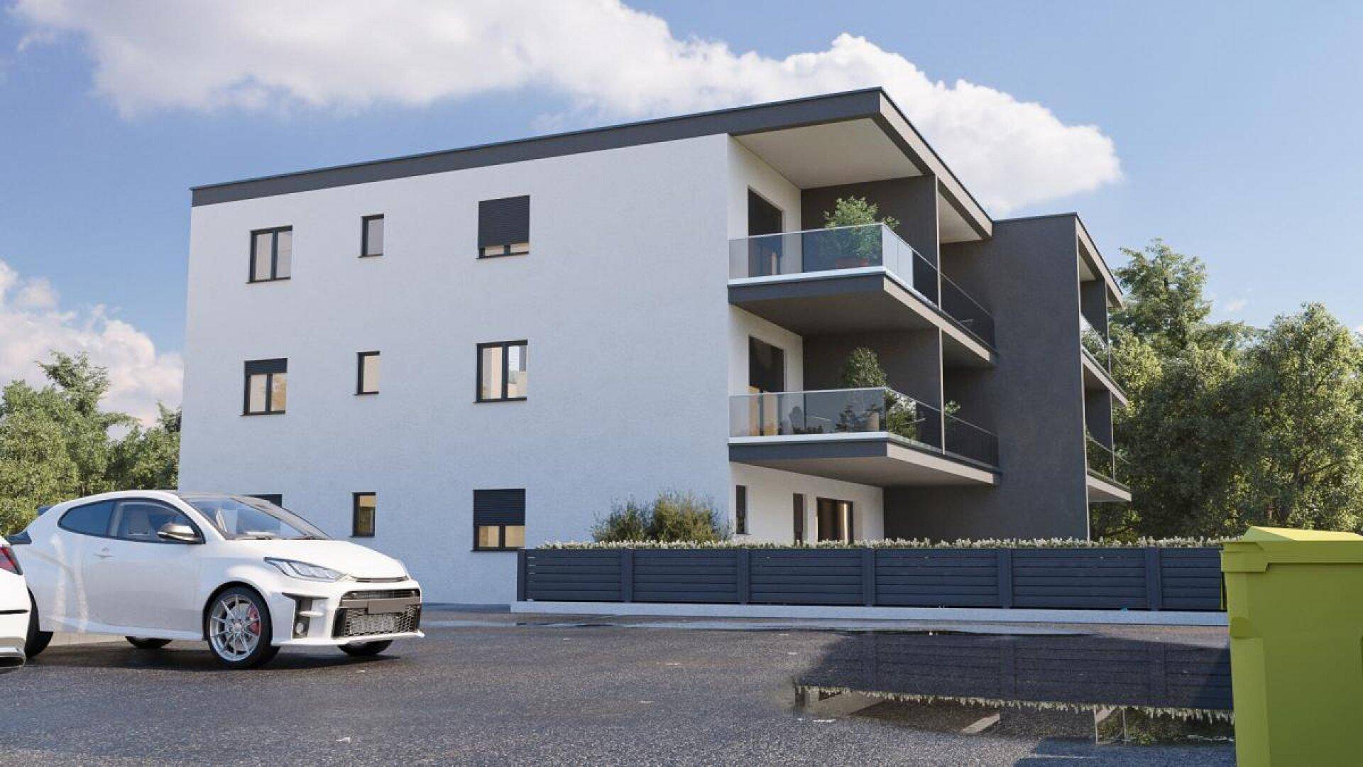 Seitenansicht der modernen Wohnanlage mit Balkonen und schlichtem Design.