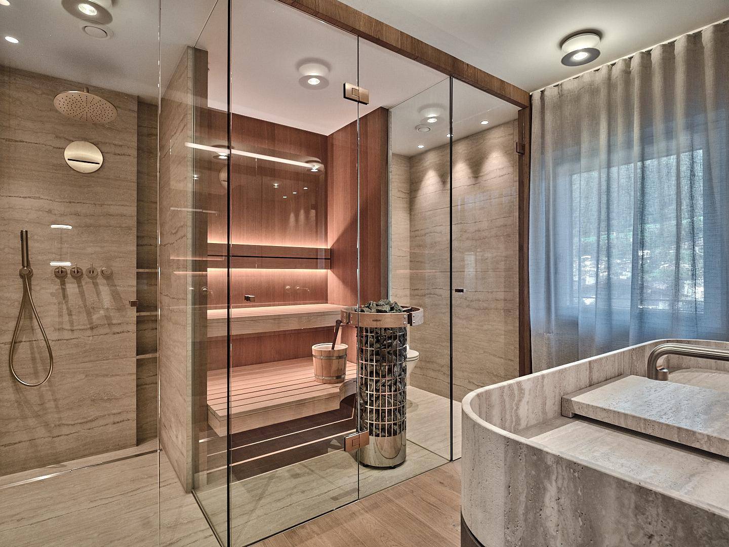 Luxuriöses Badezimmer mit integrierter Sauna, Regendusche und elegantem Steinwaschbecken.