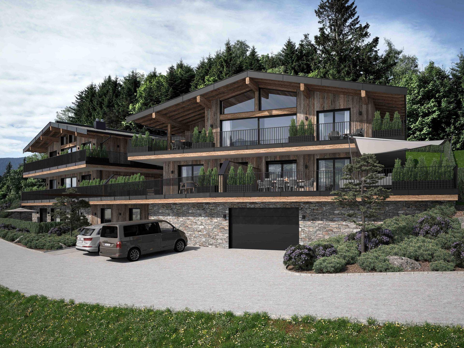 Gesamtansicht eines modernen Chalet-Gebäudes mit Holzfassade, Steinsockel, Balkonen und integrierter Garage.