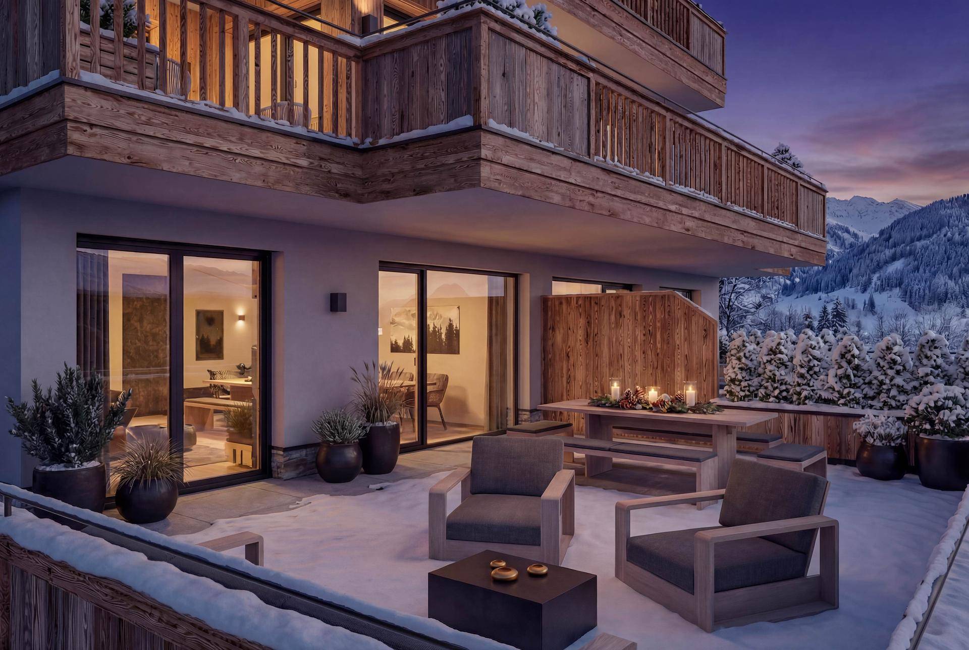 Großzügige Terrasse mit bequemen Outdoor-Möbeln und Blick auf die winterliche Bergwelt.