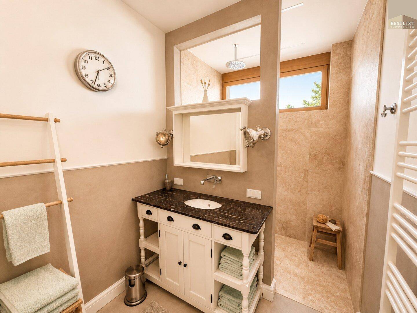 Modernes Badezimmer mit Waschtisch, begehbarer Dusche und beheiztem Handtuchhalter.