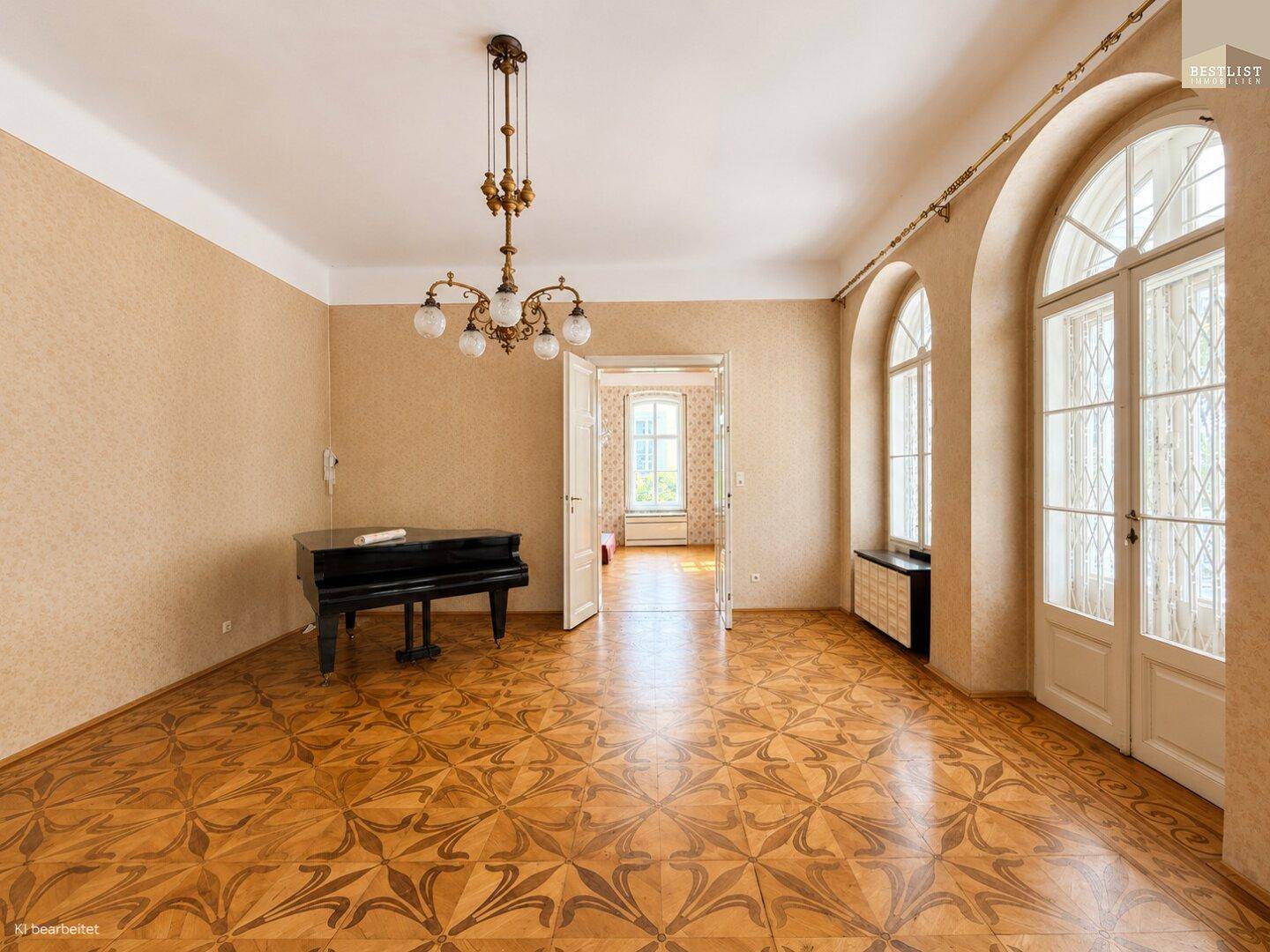 Heller Wohnraum mit elegantem Parkett, hohen Fenstern und einem klassischen Flügel als Blickfang.