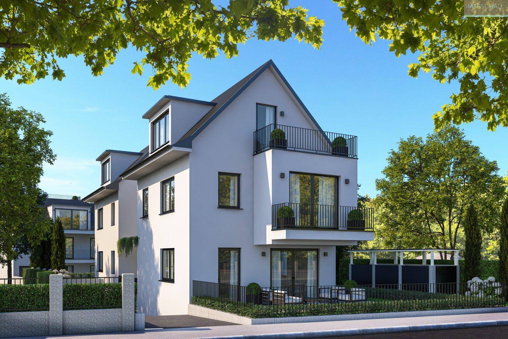 Moderne Architektur des Mehrfamilienhauses mit Balkonen und gepflegter Außenanlage unter blauem Himmel.