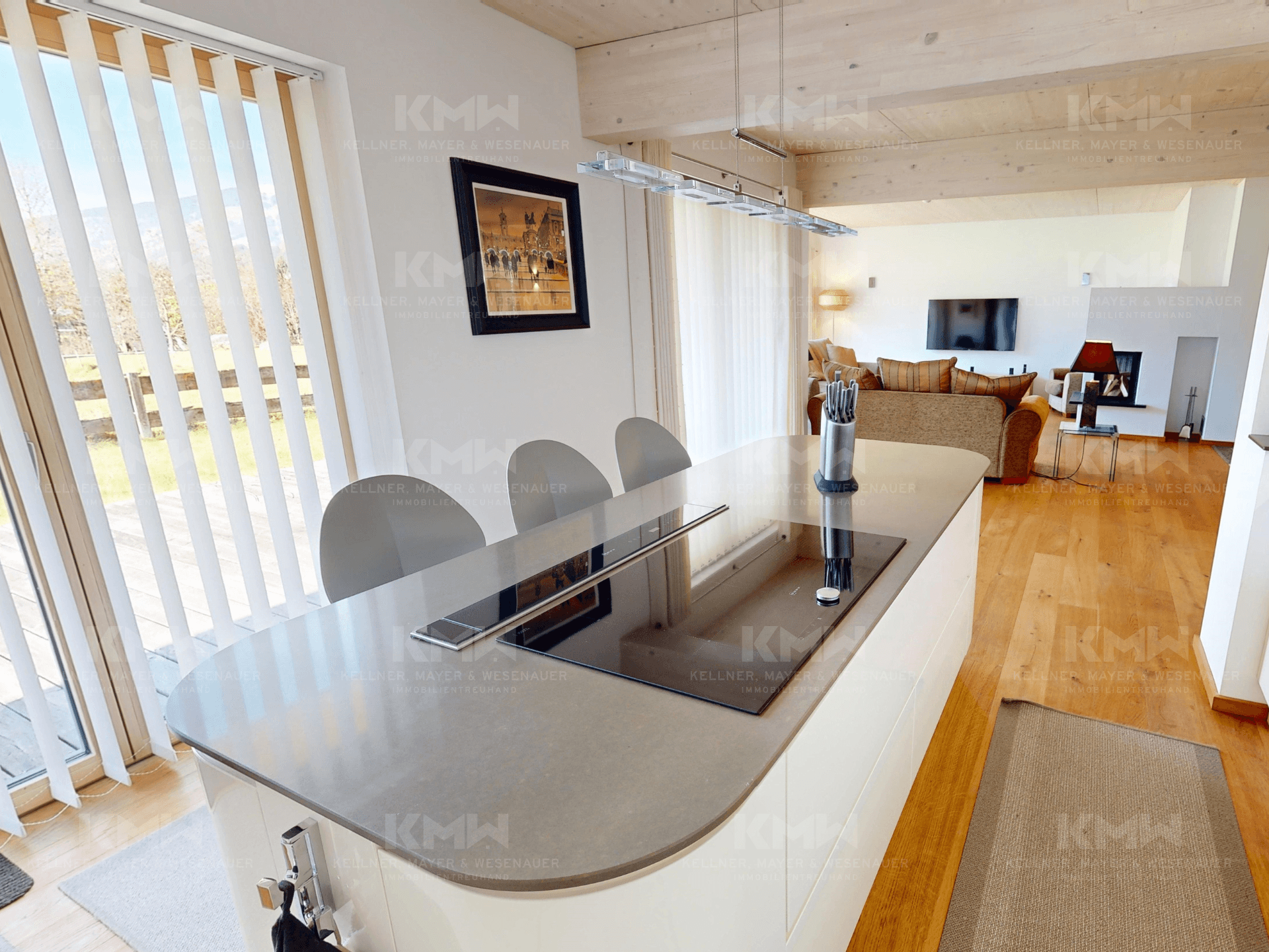 Moderne Kücheninsel mit integriertem Induktionskochfeld und Barhockern, ideal für geselliges Kochen.
