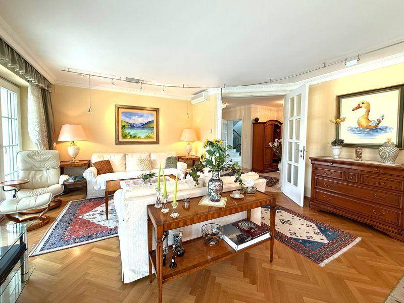 Gemütliches Wohnzimmer mit Parkettboden, bequemen Sofas und traditioneller Einrichtung.