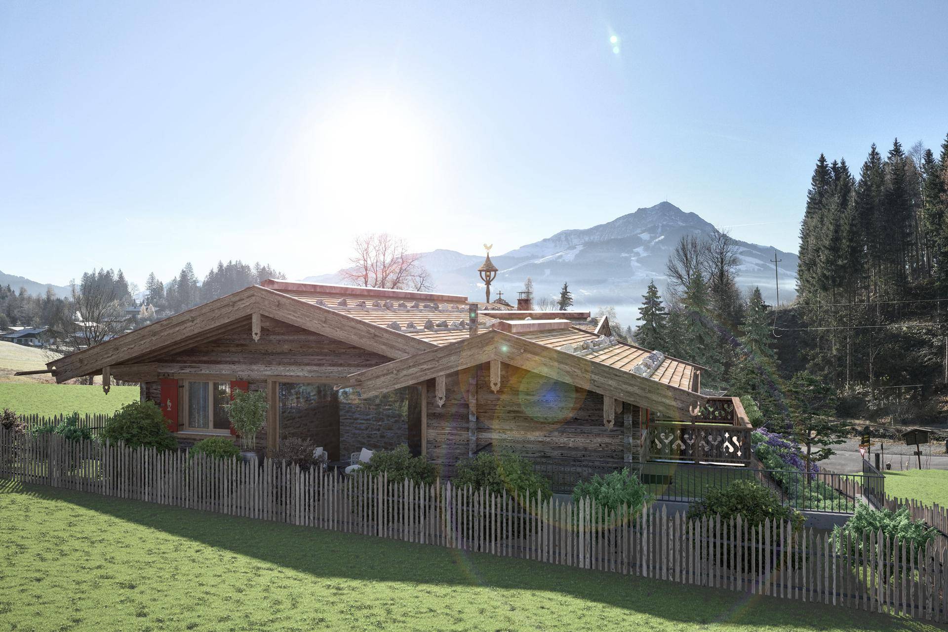 Traditionelles Holzchalet in alpiner Landschaft mit sonnigem Ausblick auf die Berge und grüne Wiesen.