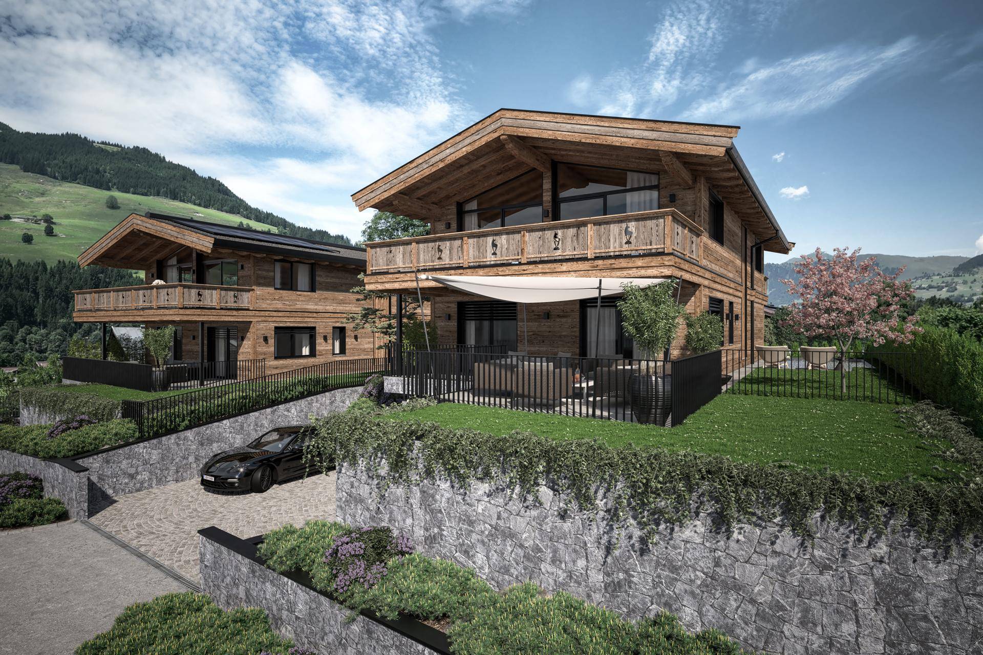 Moderne Chalets in alpiner Umgebung mit Steinfassaden und gepflegter Auffahrt.