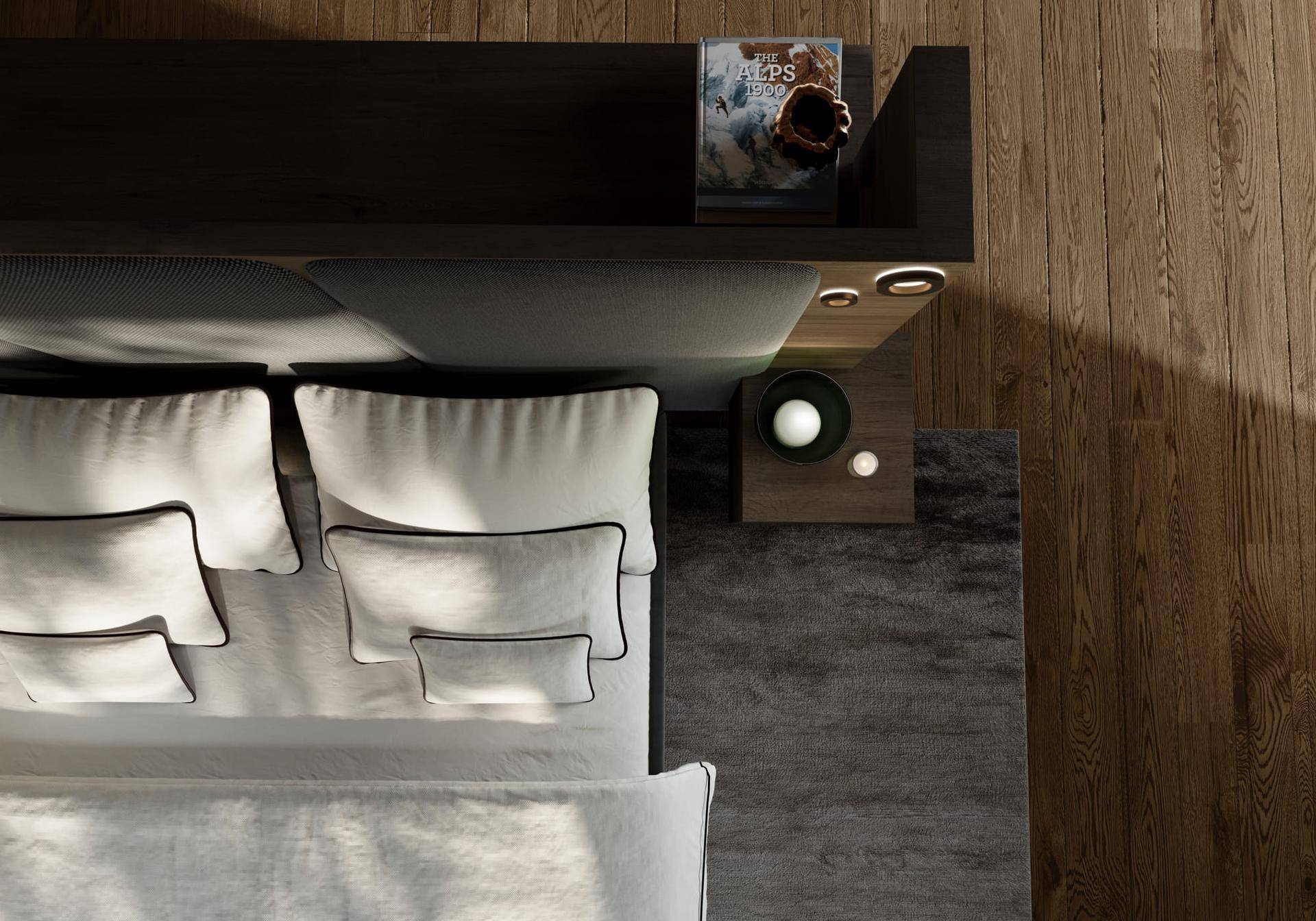 Detailansicht des Schlafzimmers mit Bett, Nachttisch und dem warmen Holzboden.