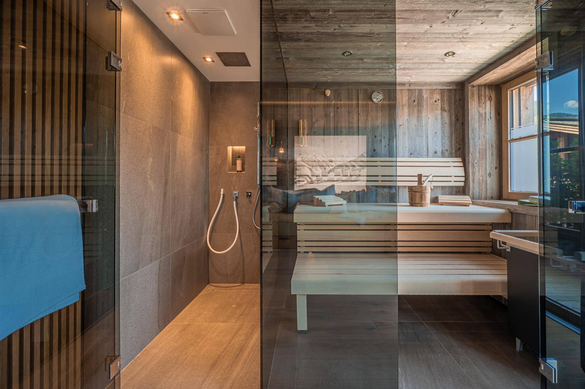 Modernes Badezimmer mit begehbarer Dusche und integrierter Sauna für entspannende Wellnessmomente.