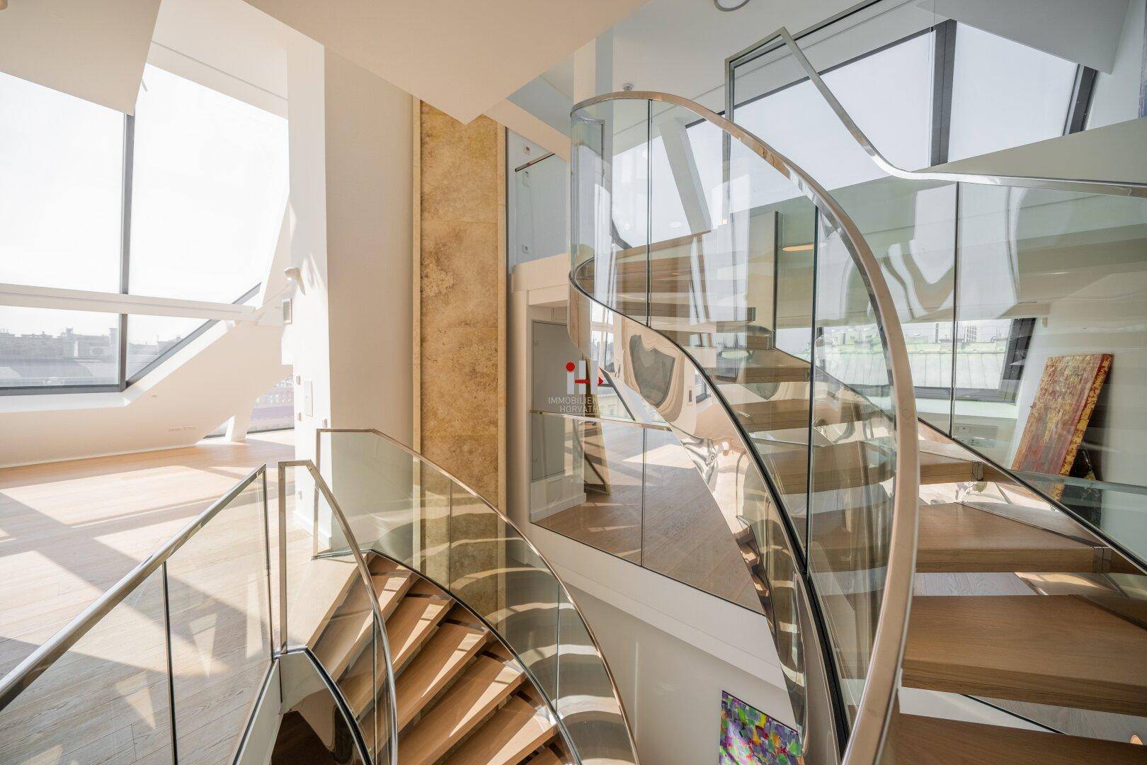 Elegante Wendeltreppe aus Glas und Holz, die verschiedene Ebenen des modernen Penthouses verbindet.