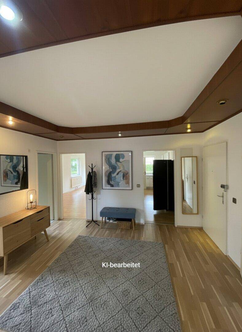Heller Flur mit Holzboden, Garderobe und dekorativer Deckenverkleidung.