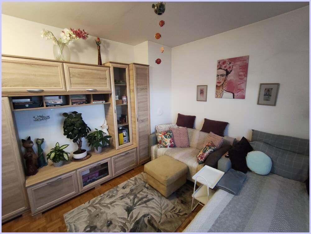 Gemütliches Wohnzimmer mit Sofa, Teppich und moderner Dekoration, bietet eine entspannte Atmosphäre.