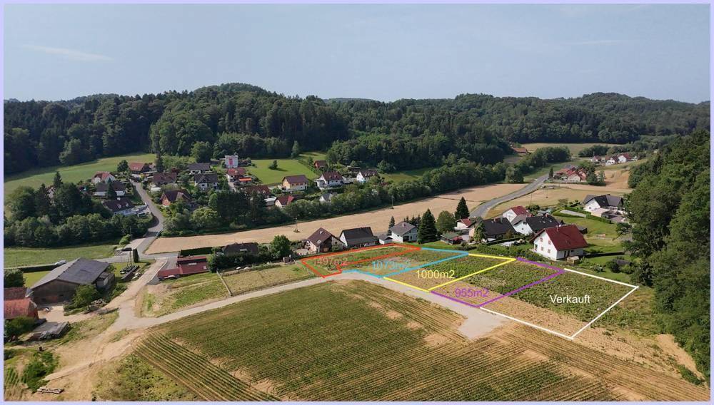Luftaufnahme mehrerer Baugrundstücke in ländlicher Umgebung mit angrenzendem Wald und Häusern.