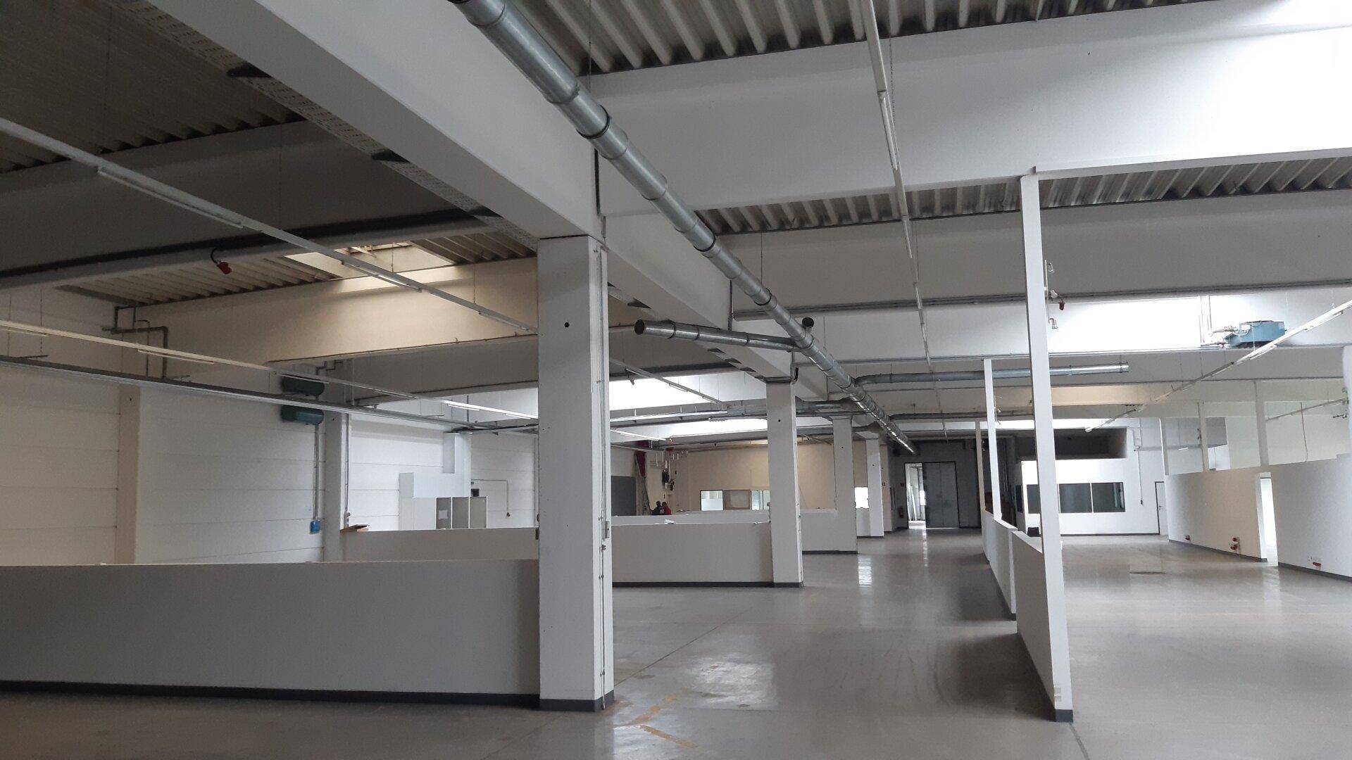 Ansicht des Industrieraums aus einem anderen Winkel, mit funktionalen Trennwänden und sichtbaren Deckenstrukturen.