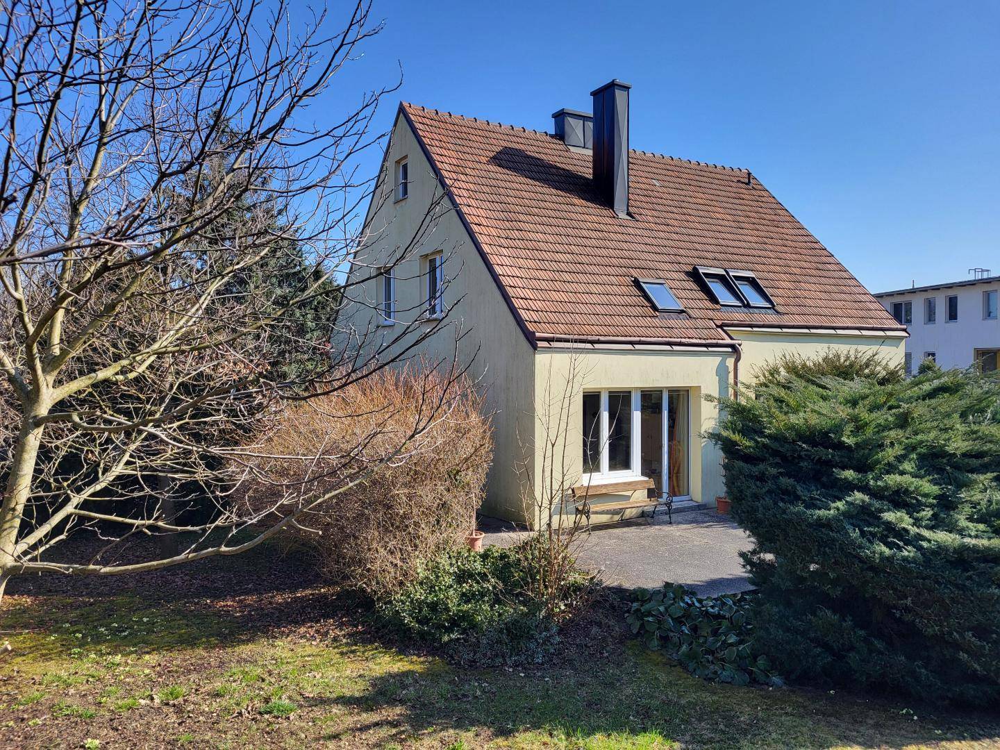 Rückseite des Hauses mit Terrasse und Zugang zum Gartenbereich.
