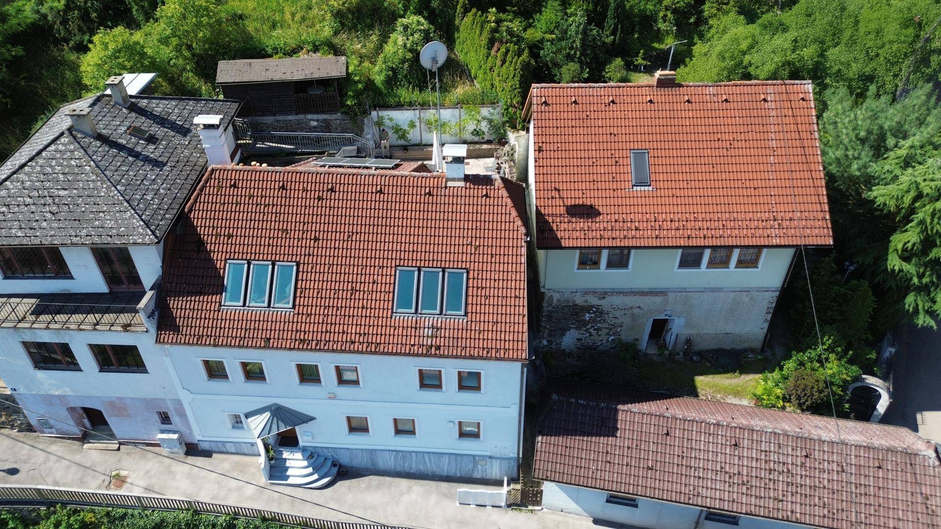 Luftaufnahme des Anwesens mit mehreren Gebäuden und roten Ziegeldächern.