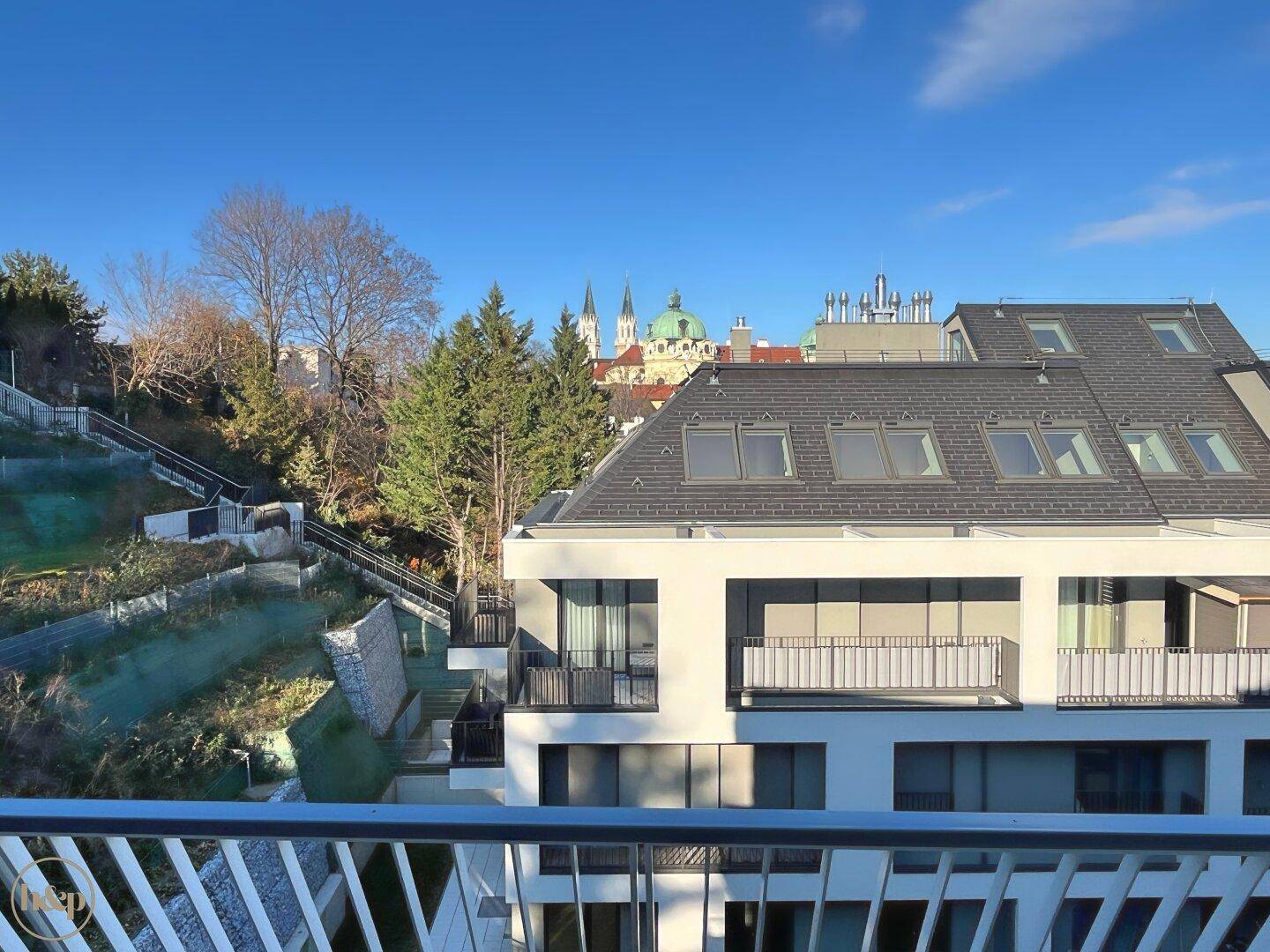 Panoramablick von der Terrasse auf die Stadt und die umliegende grüne Landschaft.