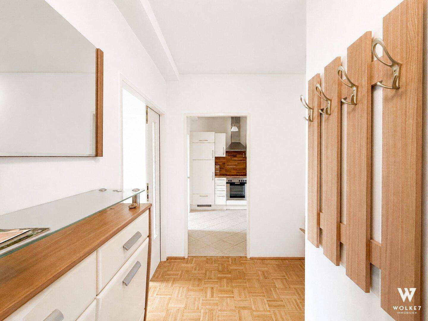 Eingangsbereich mit Garderobe, Konsole und Blick in die angrenzende Küche.