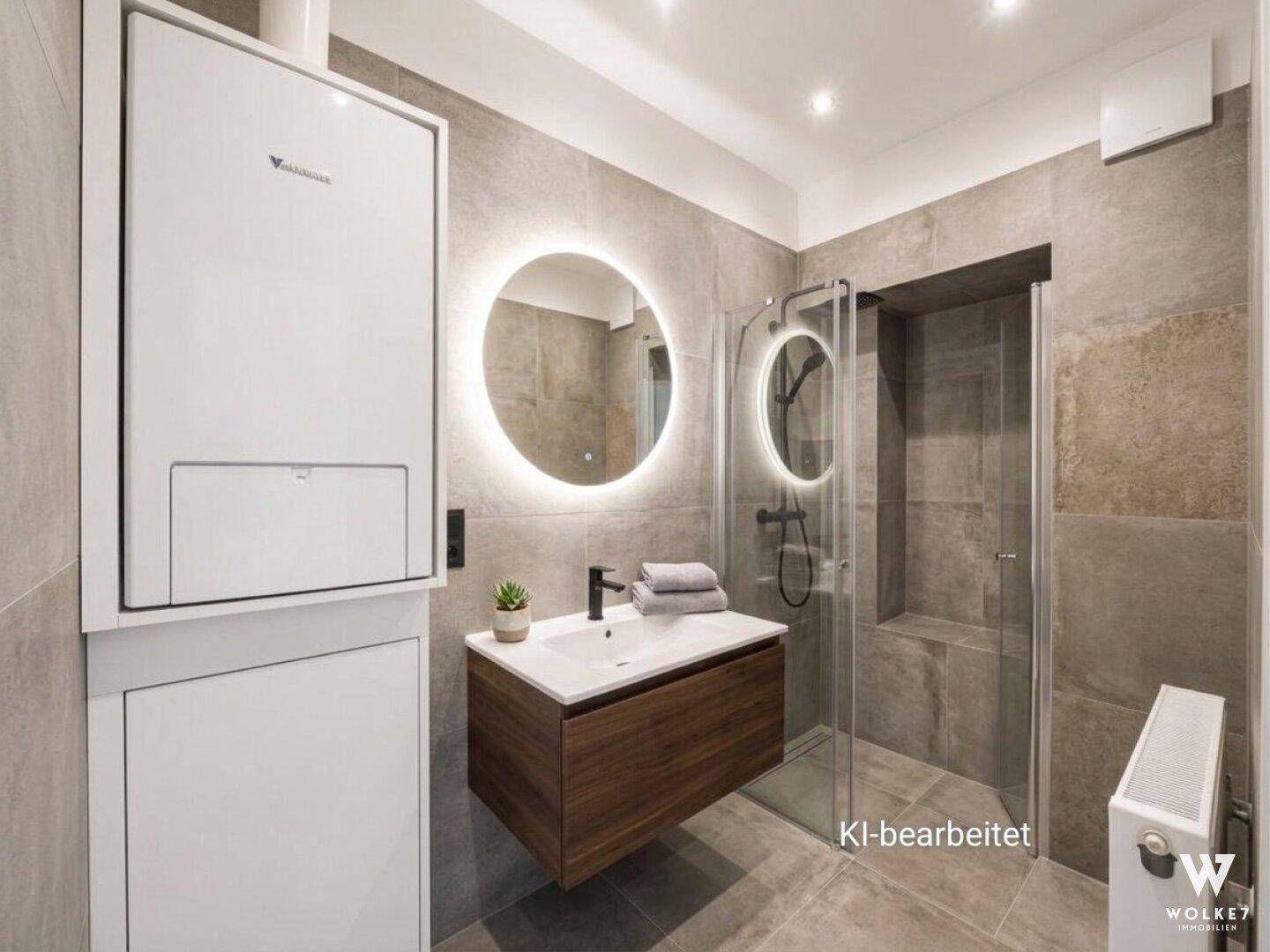 Modernes Badezimmer mit grauen Fliesen, schwebendem Waschtisch und begehbarer Dusche.