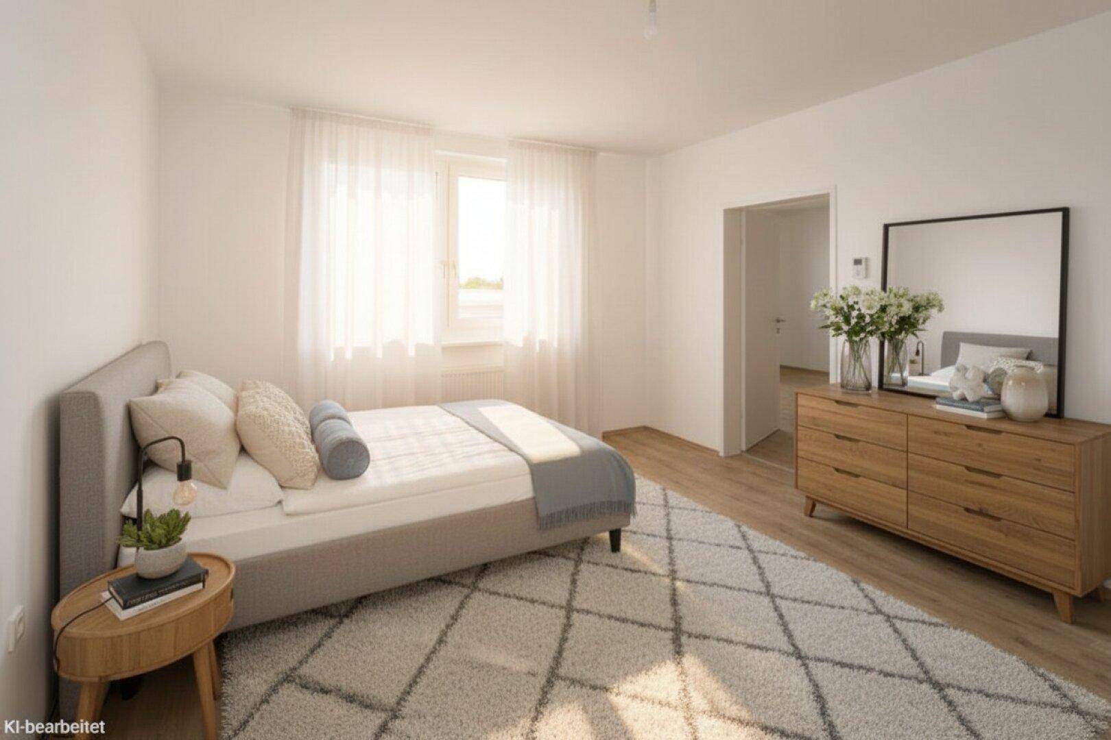 Gemütliches Schlafzimmer mit Doppelbett, Holzkommode und viel Tageslicht durch das Fenster.