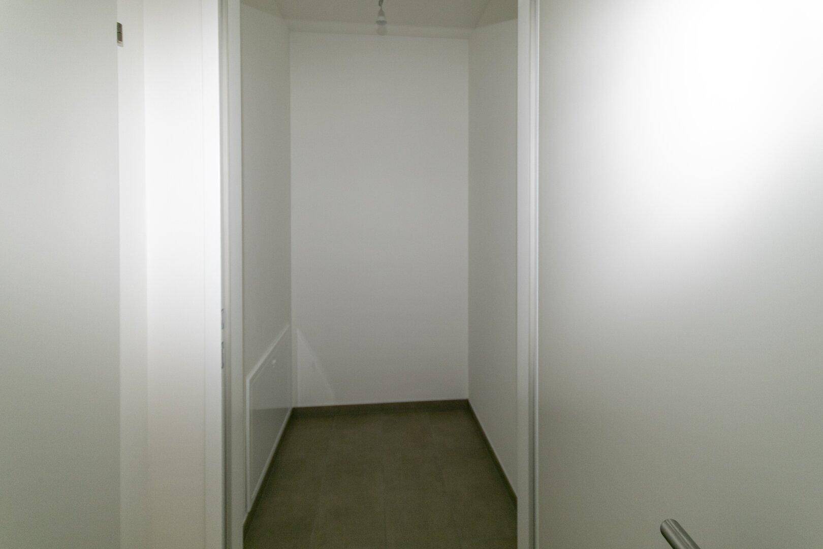 Praktischer Abstellraum mit Fliesenboden und weißen Wänden, ideal für zusätzlichen Stauraum.